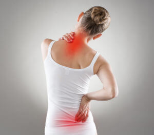 A woman holding her neck and back with red coloring to signify her pain points.
