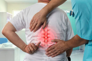 spine specialist checking the back pain of a patient