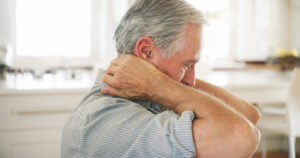 older man suffering with Neck arthritis