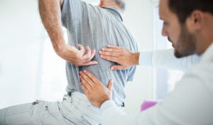 Back Specialist Analysing Back problems of Patient