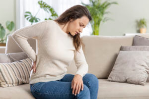 young woman suffering with back pain