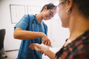 doctor helping a patient with bone fracture treatment