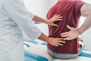 Doctors analysing back pain of doctor