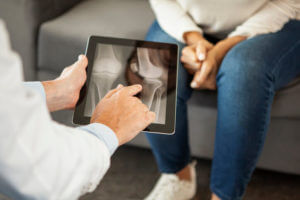 Bone Doctor explaining to senior patients the results of an examination