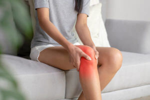 Young Woman Feeling Strain pain in her Knees