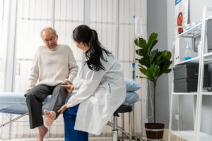 orthopedic Doctor examine senior patient leg