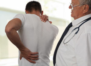 Muscular Man suffering from back and neck pain