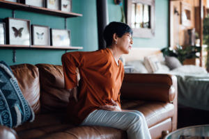 senior asian woman with lower back pain