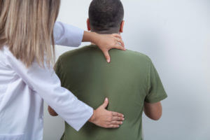 Orthopedic Sports Medicine Doctor examining patient with back problems
