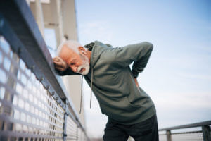 An active senior man is experiencing back pain.